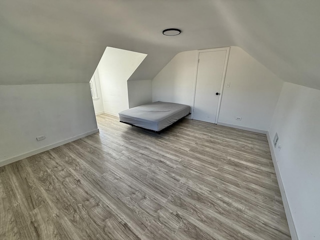 106 Kazwell St, Willow Springs, IL 60480 - additional living space featuring lofted ceiling, light wood finished floors, and baseboards