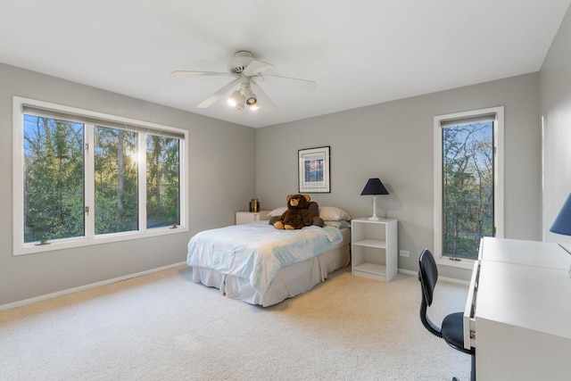 bedroom with baseboards, carpet flooring, ceiling fan, and multiple windows