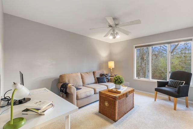 living area with baseboards, ceiling fan, visible vents, and light colored carpet