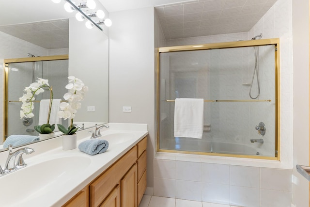 full bathroom with double vanity, a sink, tiled shower / bath, and tile patterned floors