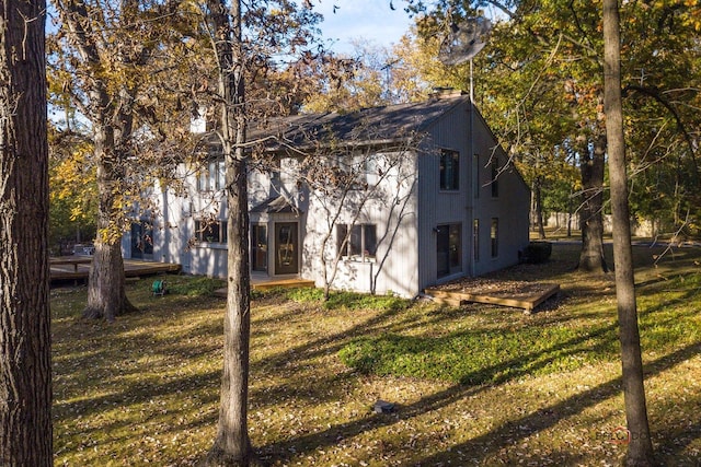 view of side of property featuring a yard and a chimney