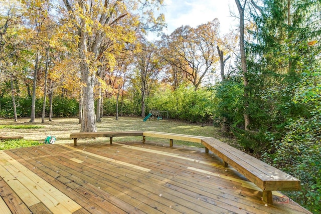 wooden terrace featuring a playground and a yard