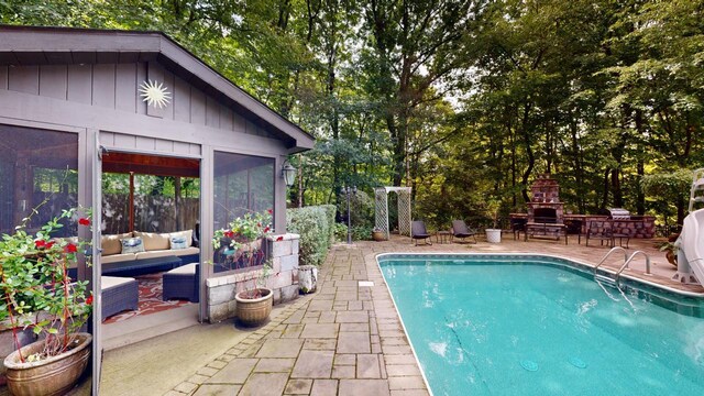 832 Ironwood Dr, Frankfort, IL 60423 - swimming pool featuring a patio area, view of scattered trees, an outdoor living space with a fireplace, and a sunroom