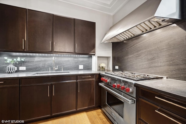 118 E Erie St Unit 19C, Chicago, IL 60611 - kitchen with a sink, designer range, custom exhaust hood, and backsplash