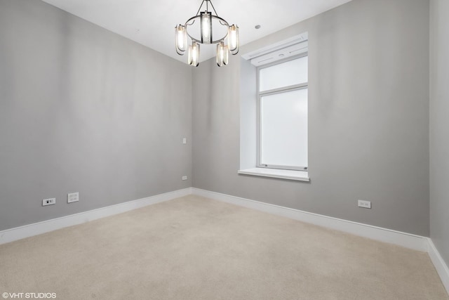 118 E Erie St Unit 19C, Chicago, IL 60611 - spare room with carpet floors, baseboards, and a notable chandelier