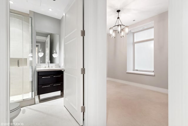 118 E Erie St Unit 19C, Chicago, IL 60611 - bathroom with a shower stall, vanity, baseboards, toilet, and an inviting chandelier
