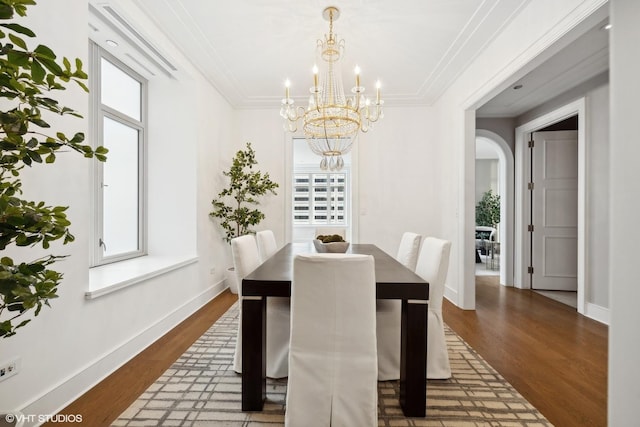 118 E Erie St Unit 19C, Chicago, IL 60611 - dining room with arched walkways, baseboards, an inviting chandelier, and dark wood-type flooring