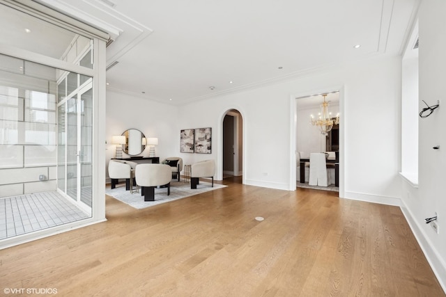 118 E Erie St Unit 19C, Chicago, IL 60611 - living area featuring crown molding, an inviting chandelier, wood finished floors, baseboards, and arched walkways