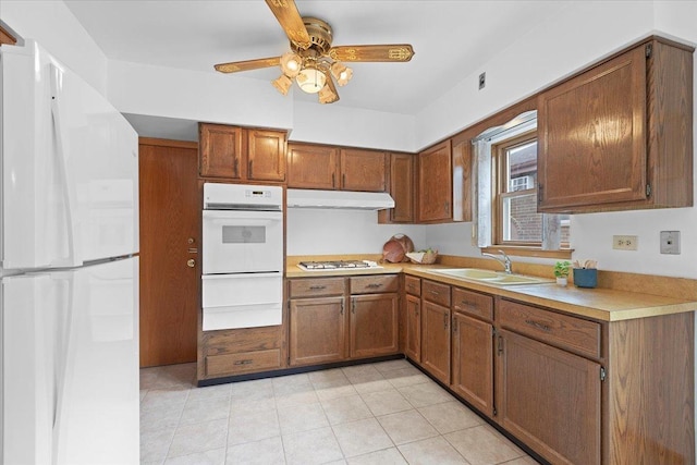 5532 W Lawrence Ave Unit 2S, Chicago, IL 60630 - kitchen with white appliances, a sink, under cabinet range hood, brown cabinetry, and a ceiling fan