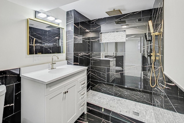 bathroom featuring vanity, marble finish floor, a marble finish shower, and toilet