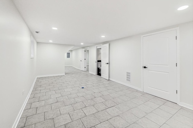 finished below grade area featuring recessed lighting, baseboards, visible vents, and light tile patterned floors