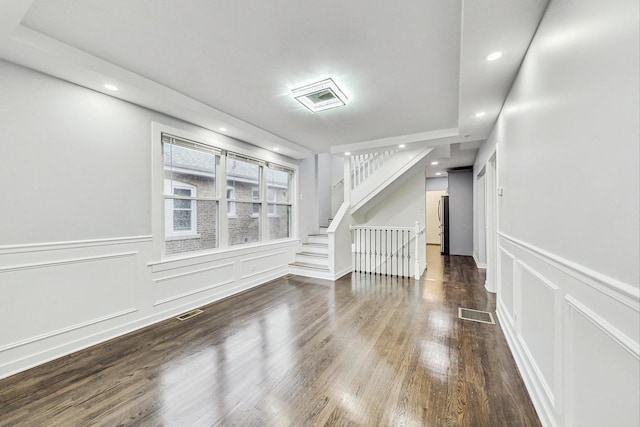unfurnished room with wainscoting, a decorative wall, recessed lighting, wood finished floors, and visible vents