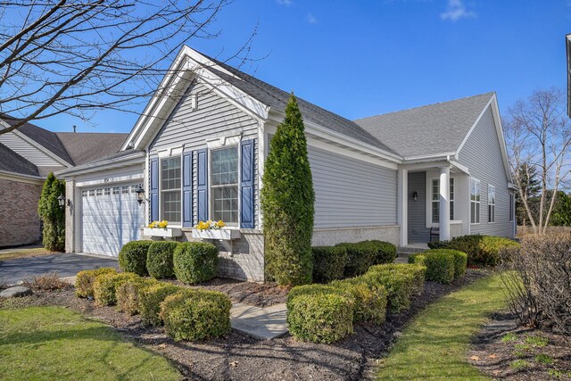 1834 Highbury Ln, Aurora, IL 60502 - view of property exterior featuring an attached garage, asphalt driveway, and roof with shingles