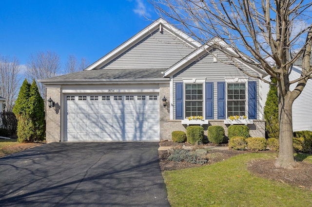 ranch-style home featuring an attached garage, driveway, and brick siding
