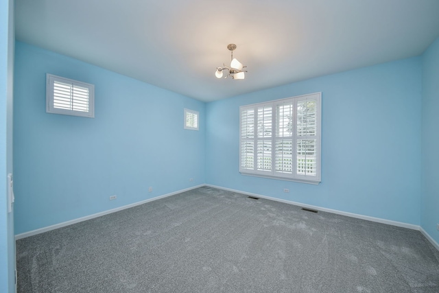carpeted empty room with baseboards and plenty of natural light