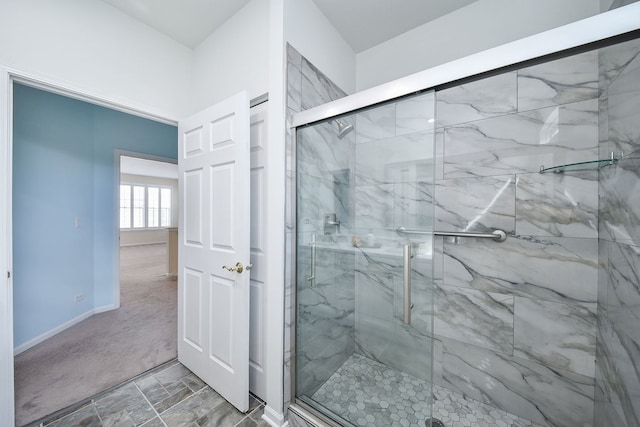 full bath featuring baseboards and a marble finish shower
