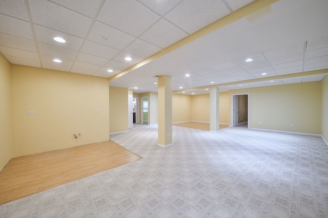 finished basement with recessed lighting, baseboards, carpet flooring, and a drop ceiling