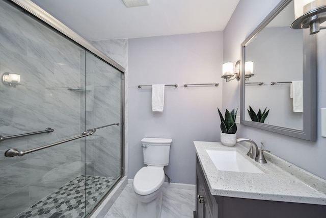 full bathroom featuring vanity, marble finish floor, toilet, baseboards, and a shower stall