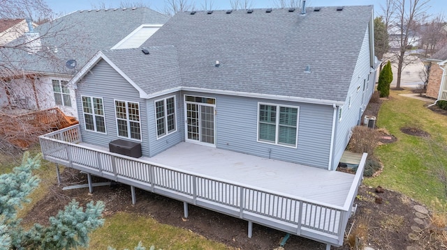 back of property with a deck, central AC unit, and roof with shingles