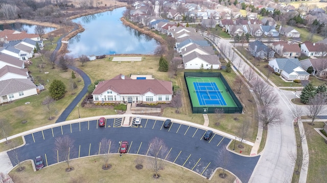 drone / aerial view with a water view and a residential view