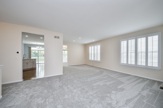 spare room with a healthy amount of sunlight, carpet floors, baseboards, and recessed lighting