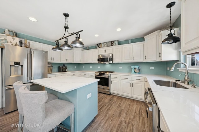 24515 Echo Ln, Manhattan, IL 60442 - kitchen featuring stainless steel appliances, a sink, a center island, wood finished floors, and recessed lighting