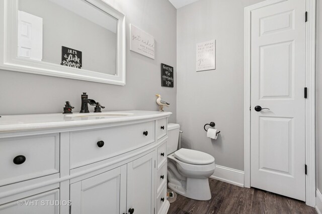 24515 Echo Ln, Manhattan, IL 60442 - half bath featuring vanity, toilet, wood finished floors, and baseboards