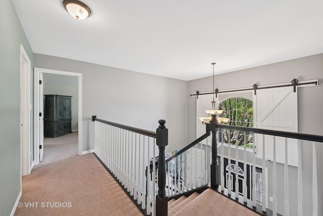 24515 Echo Ln, Manhattan, IL 60442 - corridor with carpet flooring, a barn door, baseboards, and an upstairs landing