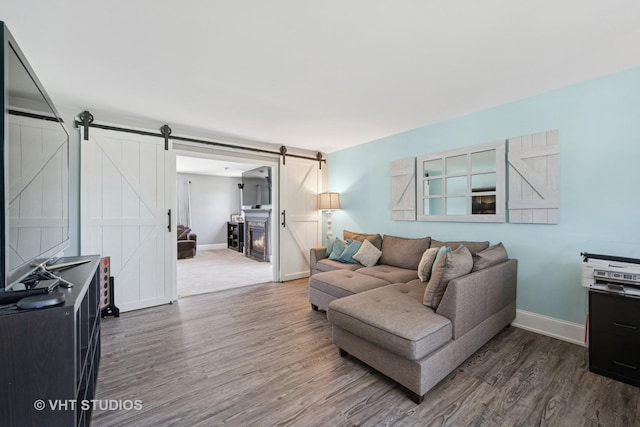 24515 Echo Ln, Manhattan, IL 60442 - living area featuring a barn door, wood finished floors, and baseboards