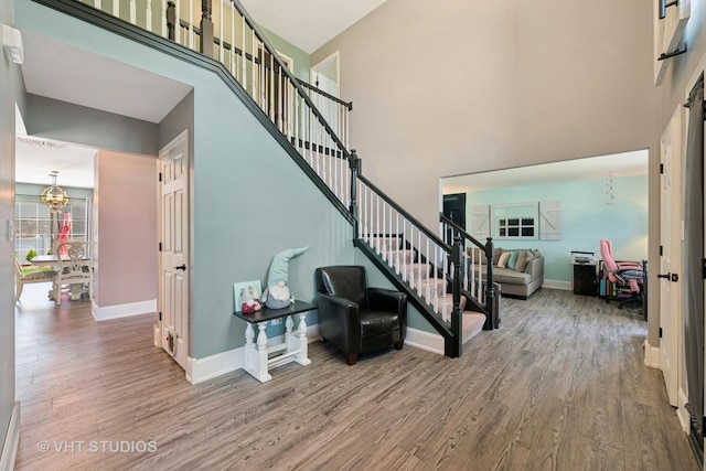 24515 Echo Ln, Manhattan, IL 60442 - stairway with wood finished floors, baseboards, a chandelier, and a high ceiling