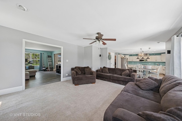 24515 Echo Ln, Manhattan, IL 60442 - living area featuring carpet floors, baseboards, ceiling fan, and a chandelier
