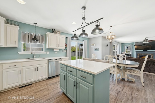 24515 Echo Ln, Manhattan, IL 60442 - kitchen with stainless steel dishwasher, a sink, white cabinetry, green cabinetry, and light wood-style floors