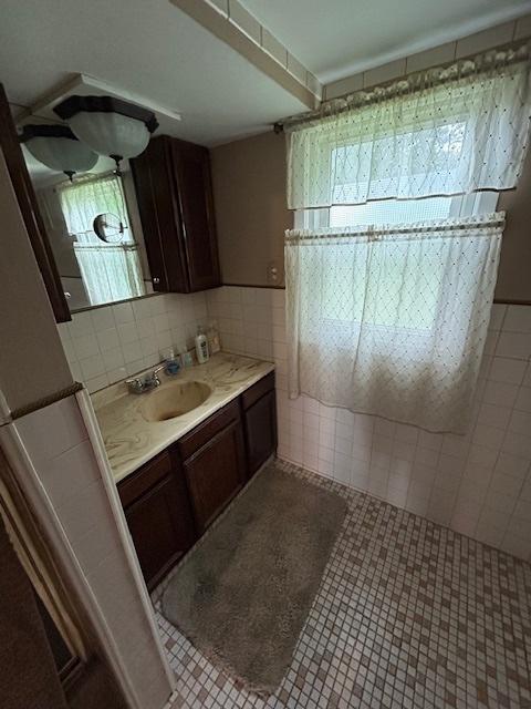 19364 US Highway 34, Princeton, IL 61356 - bathroom with vanity, tile patterned flooring, and tile walls
