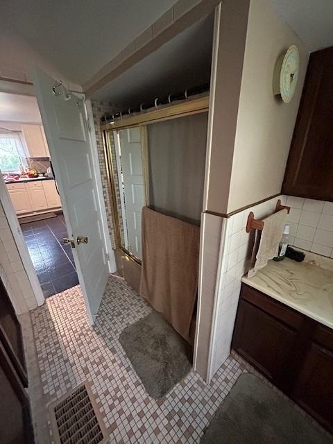 19364 US Highway 34, Princeton, IL 61356 - full bathroom with vanity, tile patterned floors, a shower, and tile walls