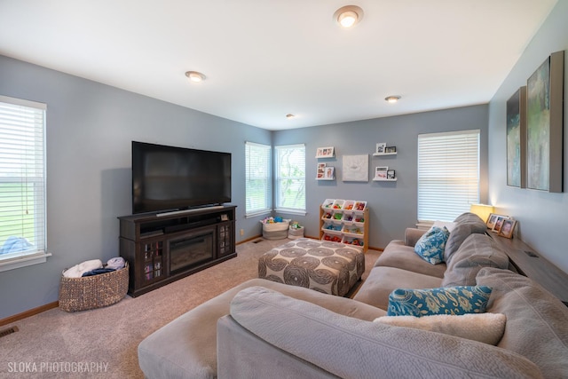living room featuring baseboards, carpet, and visible vents