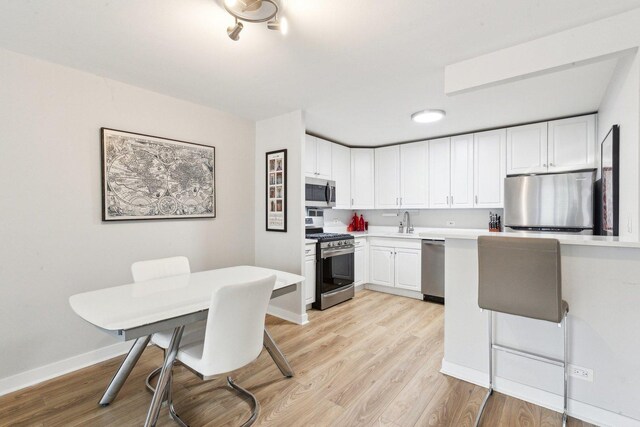 400 E Randolph St Unit 2424, Chicago, IL 60601 - kitchen with light wood-type flooring, light countertops, white cabinetry, and stainless steel appliances