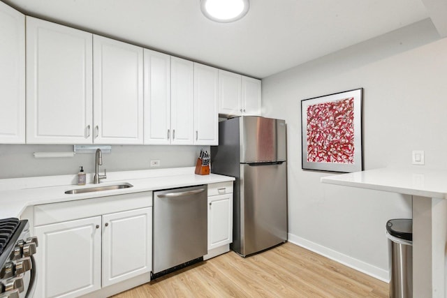 400 E Randolph St Unit 2424, Chicago, IL 60601 - kitchen featuring light wood-style floors, a sink, appliances with stainless steel finishes, and white cabinets