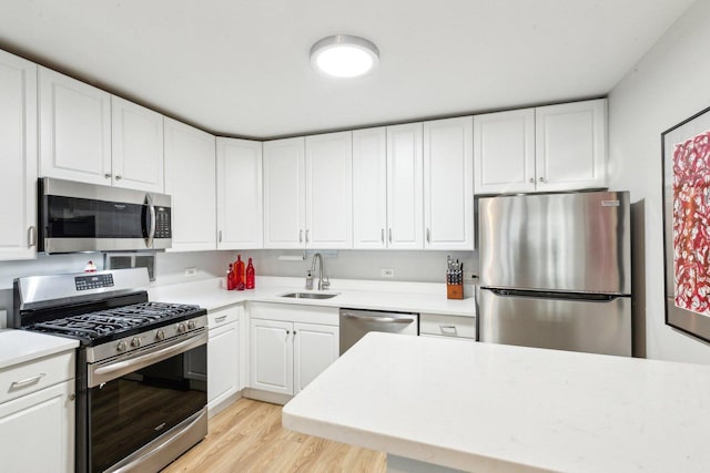 400 E Randolph St Unit 2424, Chicago, IL 60601 - kitchen featuring a sink, light countertops, white cabinets, light wood finished floors, and stainless steel appliances