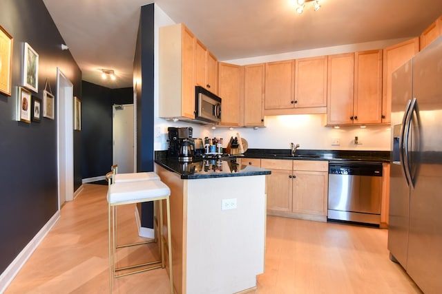 1101 S State St Unit 2100, Chicago, IL 60605 - kitchen with light brown cabinetry, appliances with stainless steel finishes, a sink, and light wood-style flooring
