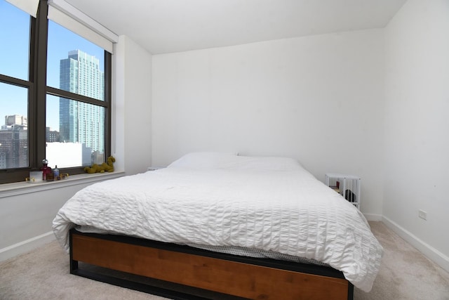 1101 S State St Unit 2100, Chicago, IL 60605 - carpeted bedroom featuring baseboards, a view of city, and radiator