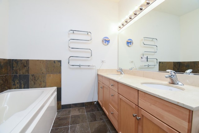1101 S State St Unit 2100, Chicago, IL 60605 - bathroom featuring a garden tub, a sink, stone finish flooring, and double vanity