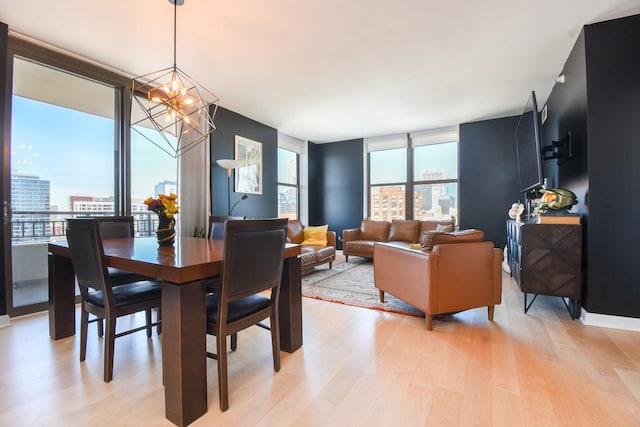 1101 S State St Unit 2100, Chicago, IL 60605 - dining room featuring an inviting chandelier, a view of city, a wall of windows, and light wood-type flooring