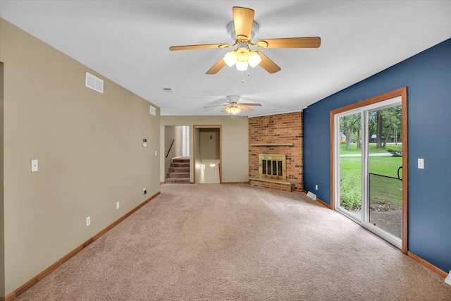 1106 Riverside Ct, Mahomet, IL 61853 - unfurnished living room featuring light colored carpet, stairs, a brick fireplace, and ceiling fan