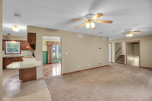 1106 Riverside Ct, Mahomet, IL 61853 - unfurnished living room featuring a ceiling fan and stairway