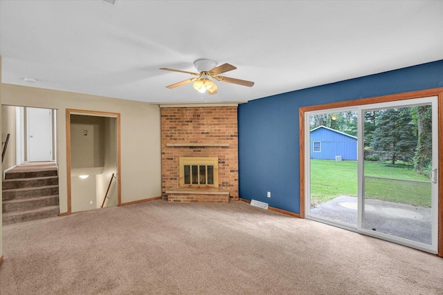 1106 Riverside Ct, Mahomet, IL 61853 - unfurnished living room featuring a ceiling fan, carpet, a fireplace, and stairway