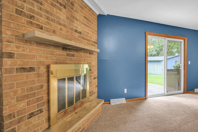 1106 Riverside Ct, Mahomet, IL 61853 - unfurnished living room with carpet and a brick fireplace