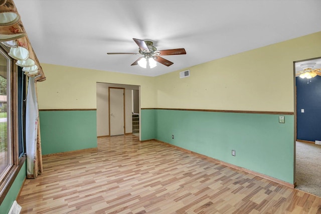 1106 Riverside Ct, Mahomet, IL 61853 - empty room featuring light wood-style flooring, a ceiling fan, and healthy amount of natural light