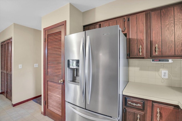 1106 Riverside Ct, Mahomet, IL 61853 - kitchen featuring stainless steel fridge, light countertops, decorative backsplash, and light flooring