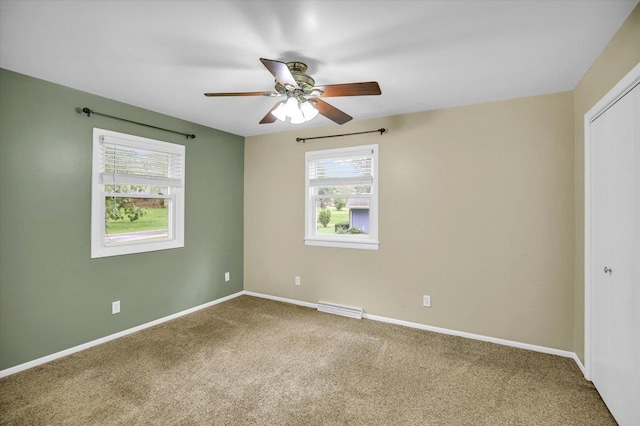 1106 Riverside Ct, Mahomet, IL 61853 - empty room with a ceiling fan, carpet flooring, and healthy amount of natural light