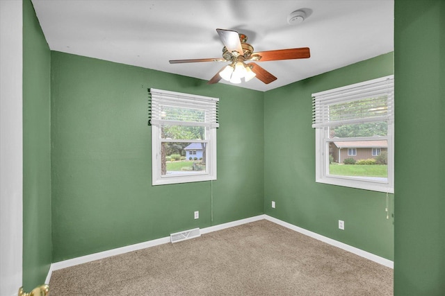 1106 Riverside Ct, Mahomet, IL 61853 - empty room with a smoke detector, a ceiling fan, and carpet